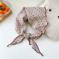 Detail of a floral cotton linen scarf tied in a knot featuring mini flower patterns - Alternating Two-color Snowflake Beige