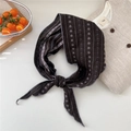 Close-up of a floral cotton linen scarf tied in a bow with delicate edge stitching - Alternating Two-color Snowflake Grey