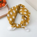 Ginger yellow cotton linen scarf featuring a white diamond pattern tied in a knot - White Rhombus Yellow Border