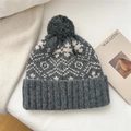 Detail of grey snowflake knit beanie with a large pompom and thick ribbed cuff - Snowflake Bird Grid Style / Light Gray