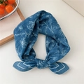 Blue cotton linen square scarf with white floral print tied in an elegant ring knot - Printed Flower Leaf Blue