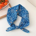 Blue floral cotton linen square scarf with white flowers and orange accents in a knot style - Blue Background Snow Flower Leaf