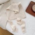 Detail of beige knit ear-flap hat with cute cat ears and long ties on white bedding - Beige (1BOWLOW Fox Rice)