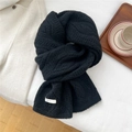 Close-up of black cable knit wool scarf with a white logo tag and soft texture - Black (6BOWLOW Hollow Hexagon Black)