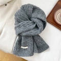 Detailed texture of thick grey wool blend knit scarf with woven BOWLOW brand label - Dark Gray