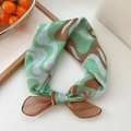 Green and brown patterned cotton-linen scarf tied in a bow with sheer fabric detail - Tropical Brown