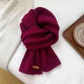 Close-up of dark burgundy knitted scarf texture with premium brown leather label detail - 23x156cm / Purple