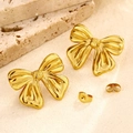 Gold bow-knot stainless steel stud earrings with irregular fold texture on sand background - High-Gloss Pleated Bowknot Style (EH055)