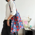 Floral block print cotton tote bag featuring deep blue fabric with red rose patterns - Standard Large / Indigo Blue