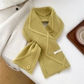 Detail of mustard yellow wool scarf showing diamond knit pattern and 100% wool label - 26*115cm / Yellow