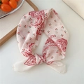 Beige cotton linen small square scarf with red paisley and cherry print tied stylishly - Cherry Paisley Red Frame