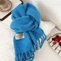 Close-up of royal blue thick bubble fleece scarf with fringes and woven brand label - 28*210cm / Aurora Blue