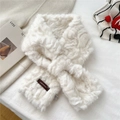 Detail of creamy white faux fur scarf showing cross-over design and brand woven label - Beige