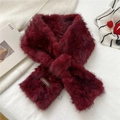 Detail of burgundy plush faux fur scarf showing the brand leather label and crossed design - Burgundy