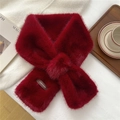 Detail of dark red faux fur scarf with cross-over design and brand label on soft knit - Burgundy