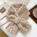 Close-up of beige faux fur cross scarf featuring a soft plush texture and brand label - Coffee