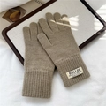 Detail view of khaki knit gloves with ribbed cuffs and decorative brand label on fabric - Simple Tawny (4HILLDI)
