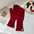 Close-up of red cable knit gloves with ribbed cuffs on a white bed sheet backdrop - One Size / Cable Knit Full Finger Gloves (5WOOL Leather Label) / Red