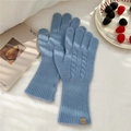 Close-up of light blue cable knit wool gloves with textured ribbed cuff and leather tag - One Size / Cable Knit Full Finger Gloves (9WOOL Leather Label) / Blue