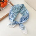 White linen scarf featuring blue paisley and floral patterns tied in a stylish knot - Floral Large Paisley Blue Frame