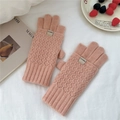 Close-up of pink diamond-patterned knit gloves with ribbed cuffs and branded label - Pink