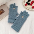 Detail of blue-grey knit gloves with diamond texture and rib cuffs for winter warmth - Blue
