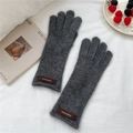 Detail of dark gray knitted gloves with cozy texture and premium leather brand tag - One Size / Gray