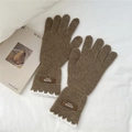 Close-up of brown knit gloves featuring white lace trim and handmade leather label - One Size / Camel (6AUVD)