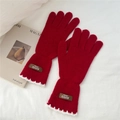 Close-up of red knit gloves featuring white scalloped edges and leather handmade label - One Size / Red (7AUVD)