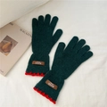 Detail of dark green knit gloves with red scalloped cuffs and leather brand label - One Size / Green (8AUVD)