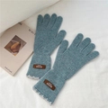 Close-up of blue knit gloves with lace cuffs and brown leather handmade label detail - One Size / Blue (9AUVD)