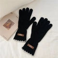 Detail of knitted gloves with grey lace cuff and brown leather handmade label - One Size / Black (11AUVD)