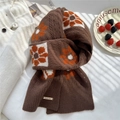 Detail of vintage flower knit wool scarf with a decorative metal brand tag - 19x157cm / Brown Floral Grid