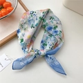 Chic blue floral cotton linen square scarf tied in a bow on a wooden tray - Colorful