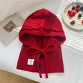 Detail of red knit balaclava showing ripple texture with black buttons and drawstring - 30x43cm / Red