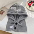 Close-up of grey knit balaclava hood featuring large black buttons and a drawstring cord - 30x43cm / Gray