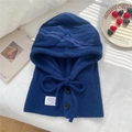 Detail of navy knit balaclava with buttons and label on white bedding with soft shadows - 30x43cm / Navy Blue
