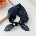 Soft black cotton bandana with white paisley and heart prints tied in a bow - Navy Star Paisley