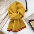 Detail of warm yellow knitted wool scarf featuring contrasting red-brown patchwork and metal button - Dark Yellow