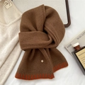 Detail of soft brown wool scarf featuring orange stripe accents and a small metal logo button - Brown