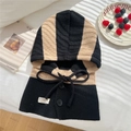 Close-up of striped knitted balaclava hood with black drawstrings and button details - Black & Camel Balaclava (Single)