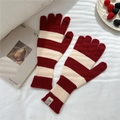 Close-up of red and white striped knit gloves with functional finger openings and woven tag - Red & White Gloves (Single)