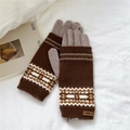 Detail view of winter knitted gloves with geometric jacquard pattern and leather label - Brown