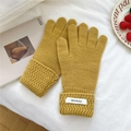 Detail of ginger yellow 100% wool knitted gloves featuring wavy scalloped wrist cuffs - Yellow