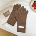 Close-up of brown 100% wool knitted gloves featuring elegant wavy ribbed cuffs and labels - One Size / Brown (7WOOL)