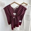 Detail of red and grey striped knit shawl with knots and logo label on a white shirt - Red-Grey Striped