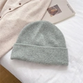 Detail of dark grey knit beanie with colorful flecks on a soft textured background - One Size / Light Grey Green