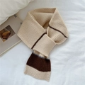 Close-up of soft striped knit scarf with hole fastening on a cozy white background - Off White