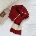 Detail of chunky knit scarf showing red and white stripes with beige and grey blocks - Red
