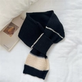 Detail of black knit scarf with grey and beige stripes featuring a cross-over slit design - Black